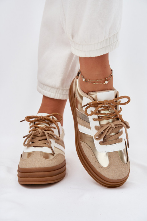 À modalo de tênis Feminino com uma plataforma Z PodParaójnym Amarrandom com padrões de pele de leopardo cor dourada Niteria À modalo de tênis Feminino com uma plataforma Z PodParaójnym Amarrandom com padrões de pele de leopardo cor dourada Niteria