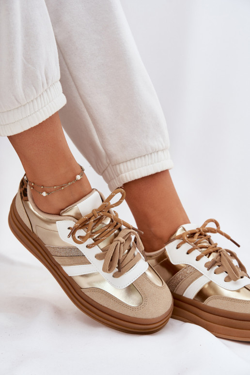 À modalo de tênis Feminino com uma plataforma Z PodParaójnym Amarrandom com padrões de pele de leopardo cor dourada Niteria À modalo de tênis Feminino com uma plataforma Z PodParaójnym Amarrandom com padrões de pele de leopardo cor dourada Niteria