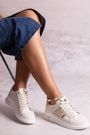 Tênis bege decorados com... 2