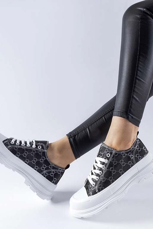 Tênis preto decorado com o monograma...