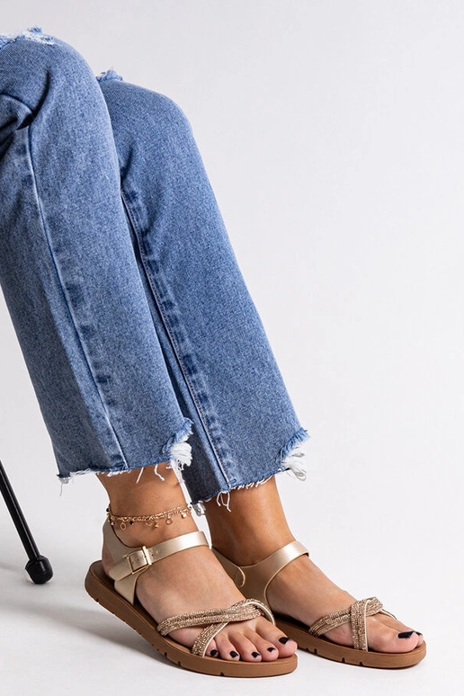 Sandálias douradas decoradas com...