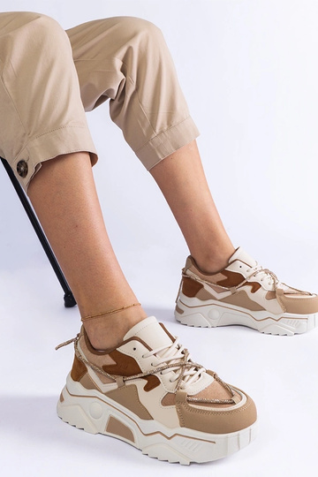 Tênis marrom decorado com...