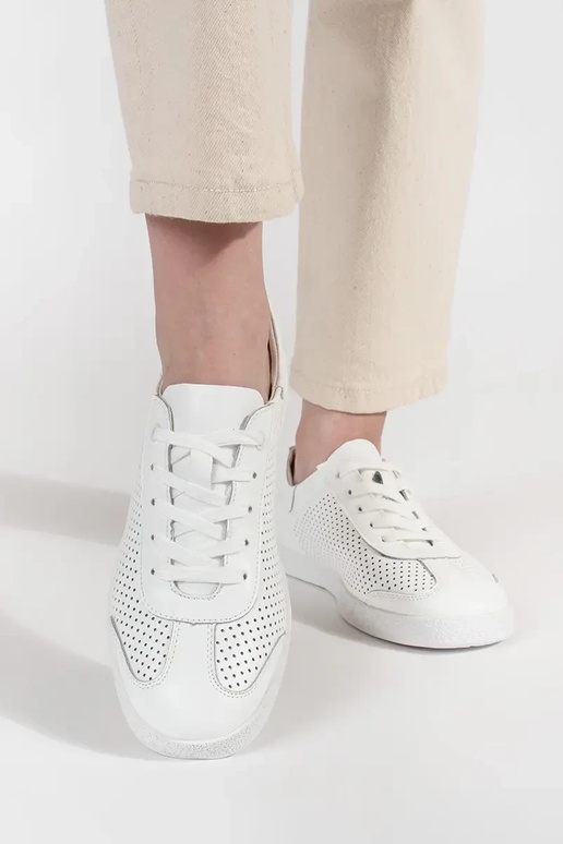 Tênis esportivos brancos perfurados... Tênis esportivos brancos perfurados...