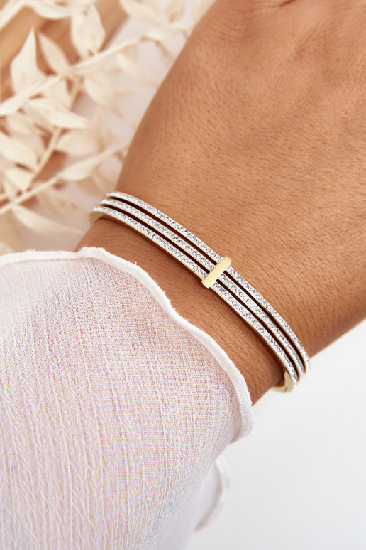 Um bracelete de aço inoxidável com olhos brilhantes cor dourada