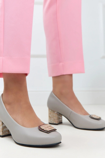 Sapatos de couro cinzentos em uma coluna decorativa Potocki