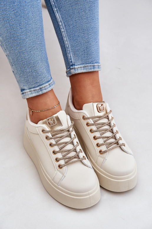 À modalo de tênis com uma plataforma Com decoraçõesi SznuróParakami bege Fonetha À modalo de tênis com uma plataforma Com decoraçõesi SznuróParakami bege Fonetha